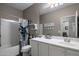 Bright bathroom featuring a vanity with a large mirror, updated fixtures, and shower/tub combination at 11148 E Tumbleweed Ave, Mesa, AZ 85212