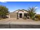 Charming single-story home featuring a well-maintained landscaped front yard, a two car garage and stone accents at 11148 E Tumbleweed Ave, Mesa, AZ 85212