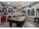 Entertaining game room featuring a pool table, TV, and sports memorabilia for fun gatherings and relaxation at 11148 E Tumbleweed Ave, Mesa, AZ 85212