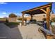 Landscaped backyard with artificial turf and a gazebo offering a relaxing outdoor space at 11148 E Tumbleweed Ave, Mesa, AZ 85212