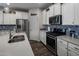 Kitchen featuring white cabinets, stainless steel appliances, quartz counters, and stylish backsplash at 11148 E Tumbleweed Ave, Mesa, AZ 85212