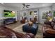 Cozy living room boasts a fireplace, plush seating, and a ceiling fan for comfort at 11148 E Tumbleweed Ave, Mesa, AZ 85212