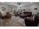 Cozy living room with plush seating, a ceiling fan, and sliding doors leading to the outdoor space at 11148 E Tumbleweed Ave, Mesa, AZ 85212