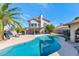 Stunning backyard featuring a pool, patio, lush landscaping, and an outdoor seating area perfect for relaxation at 1313 W Glenmere Dr, Chandler, AZ 85224