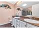 Well-lit bathroom with dual sinks, a glass-enclosed shower, and decorative floral accents at 1313 W Glenmere Dr, Chandler, AZ 85224