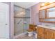 Bathroom with a glass-door shower, neutral walls, and vanity with wooden cabinets for storage at 1313 W Glenmere Dr, Chandler, AZ 85224