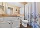 Bathroom with a shower featuring a curtain, a vanity with a sink, and a toilet in a compact space at 1313 W Glenmere Dr, Chandler, AZ 85224
