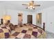 Bright bedroom featuring a bed with patterned bedding, neutral walls, and ensuite bathroom and wardrobe access at 1313 W Glenmere Dr, Chandler, AZ 85224