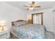 Bright and airy bedroom with floral bedding, a ceiling fan, and ample natural light at 1313 W Glenmere Dr, Chandler, AZ 85224