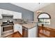 View of the kitchen with stainless steel appliances and a view of the dining area at 1313 W Glenmere Dr, Chandler, AZ 85224