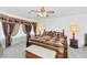 Main bedroom features a ceiling fan, carpet, and a large bed at 1313 W Glenmere Dr, Chandler, AZ 85224