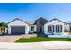 Charming single-story home featuring a well-manicured lawn, brick driveway, and inviting front entry at 14429 N 75Th Dr, Peoria, AZ 85381