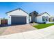 Attractive single-Gathering home with a brick driveway, a gray garage door, and manicured landscaping at 14429 N 75Th Dr, Peoria, AZ 85381