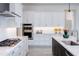 Bright kitchen featuring white cabinets, stainless steel appliances, and a large island at 14429 N 75Th Dr, Peoria, AZ 85381