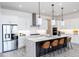 Bright, modern kitchen features stainless steel appliances, large island with seating, and sleek white cabinetry at 14429 N 75Th Dr, Peoria, AZ 85381