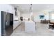 Open kitchen and dining area boasts an oversized island, stainless appliances, and eat-in dining at 14429 N 75Th Dr, Peoria, AZ 85381