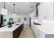 Modern kitchen featuring a large island, stainless steel appliances and sleek, white cabinetry at 14429 N 75Th Dr, Peoria, AZ 85381