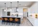 Modern kitchen featuring island with barstool seating, stainless appliances and white cabinetry at 14429 N 75Th Dr, Peoria, AZ 85381