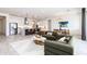 Bright, open living space showcases kitchen with an island, modern sofa and dining area at 14429 N 75Th Dr, Peoria, AZ 85381