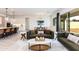 Bright, open-concept living room with comfortable seating, modern decor, and views into the dining area at 14429 N 75Th Dr, Peoria, AZ 85381