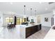 Open concept living area with kitchen island, dining table and sliding glass doors at 14429 N 75Th Dr, Peoria, AZ 85381