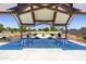 Community picnic area with picnic tables, barbecue grills, and sunshade in a well-landscaped neighborhood park at 14429 N 75Th Dr, Peoria, AZ 85381