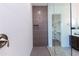 Modern walk-in shower featuring gray accent tiles, white walls, a niche, and glass door at 14429 N 75Th Dr, Peoria, AZ 85381