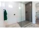 Contemporary walk-in shower featuring sleek gray accent tiles, white walls, and glass enclosure at 14429 N 75Th Dr, Peoria, AZ 85381