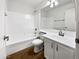 Bright bathroom featuring a tub with white tile surround and a single sink vanity at 1488 W Page Ave, Gilbert, AZ 85233