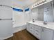 Modern bathroom features double vanity, tub, shower, and wood-style flooring at 1488 W Page Ave, Gilbert, AZ 85233
