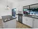 Modern kitchen features granite countertops, white cabinetry, and stainless steel appliances at 1488 W Page Ave, Gilbert, AZ 85233
