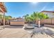 An outdoor kitchen with built-in seating adds flair to this backyard oasis at 15009 S 47Th St, Phoenix, AZ 85044