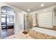 Elegant bathroom with a soaking tub, glass shower, and access to the main bedroom at 15009 S 47Th St, Phoenix, AZ 85044
