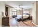This spacious bedroom boasts a four-poster bed, wood floors, and ample natural light at 15009 S 47Th St, Phoenix, AZ 85044