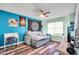 This bedroom has blue and mint green walls with a futon couch and a desk at 15009 S 47Th St, Phoenix, AZ 85044