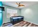 Cozy bedroom with wood floors, neutral walls and pullout bed with storage drawers at 15009 S 47Th St, Phoenix, AZ 85044