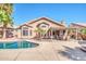 A gorgeous backyard view showcasing the home, pool, and outdoor patio area at 15009 S 47Th St, Phoenix, AZ 85044