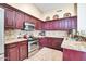 Well-equipped kitchen featuring stainless steel appliances, custom cabinetry, and granite countertops at 15009 S 47Th St, Phoenix, AZ 85044