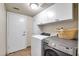 Laundry room featuring a white door, white cabinets, a white washer, and gray dryer at 15009 S 47Th St, Phoenix, AZ 85044