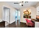 Bright office features a unique pink chair and a vibrant painting on the wall at 15009 S 47Th St, Phoenix, AZ 85044