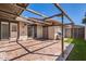 A backyard patio area has red brick pavers, a wooden beam canopy, a BBQ grill, and a yard area at 1550 N Stapley Dr # 21, Mesa, AZ 85203