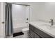 A clean bathroom with a shower and bathtub combo, a modern vanity, and black and white patterned tile floor at 1550 N Stapley Dr # 21, Mesa, AZ 85203