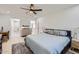 Spacious bedroom with ceiling fan, a study area and access to an ensuite bathroom at 1550 N Stapley Dr # 21, Mesa, AZ 85203