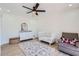 Bright Bedroom with a white crib, dresser, and cozy armchair at 1550 N Stapley Dr # 21, Mesa, AZ 85203
