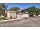 Charming single-story home featuring a brick facade, a two-car garage, and a well-maintained front yard at 1550 N Stapley Dr # 21, Mesa, AZ 85203