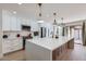 Well-lit kitchen features a large island with a sink, stainless steel appliances, and pendant lights at 1550 N Stapley Dr # 21, Mesa, AZ 85203
