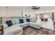 Open-concept living room with a large sectional sofa and views into the kitchen and dining area at 1550 N Stapley Dr # 21, Mesa, AZ 85203