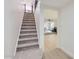 View of carpeted stairs leading to the upper level, with a glimpse of the open-concept living area beyond at 1550 N Stapley Dr # 21, Mesa, AZ 85203