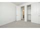 Clean bedroom with neutral carpet, closet, and doorway, offering a basic and functional space at 1565 E Tiffany Way, Gilbert, AZ 85298