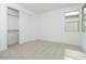 Bright bedroom with neutral carpet, a closet with sliding doors, and a window at 1565 E Tiffany Way, Gilbert, AZ 85298